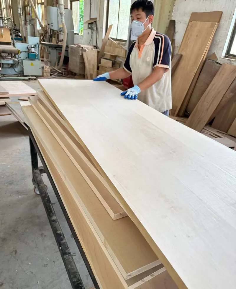 Wood countertop sanding and quality check Worker sanding and quality checking wood countertop panel